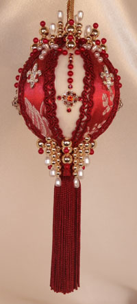 This Victorian Style Ornament is created with the most beautiful shades of red, deep and rich, monochromatic set off with a staggered Fleur De Lis Rhinestone button and elaborately hand set Swarovski Crystals