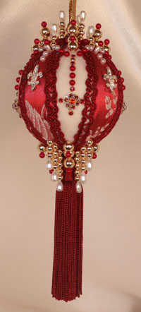 This Victorian Style Ornament is created with the most beautiful shades of red, deep and rich, monochromatic set off with a staggered Fleur De Lis Rhinestone button and elaborately hand set Swarovski Crystals