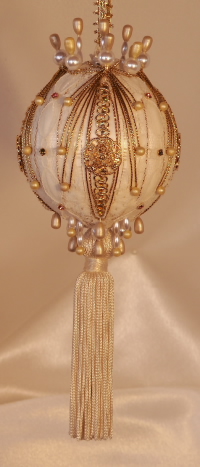 An ivory tassel, velvet and Swarovski Crystals on this collectible, giftable heirloom ornament