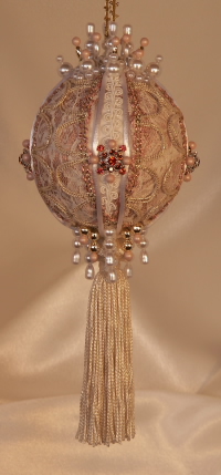 Beautiful gold loop trim, rare and vintage, ivory satin scrolled trim, garnet and siam Swarovski Crystals and a lush ivory tassel on this heirloom ornament