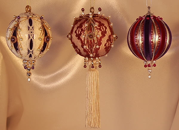Deep lush purple, and equally luscious burgundy work together in contrast on the ivory bases of this gorgeous set of three Victorian Ornaments