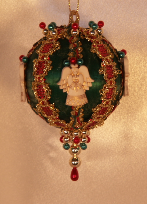 A Guardian Angel watches over you on this Traditional Red and Green Christmas Ornament