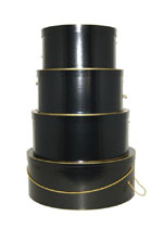 Glossy black hatboxes in a nested set of four trimmed in gold