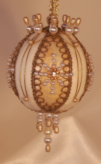 Signature lacing and Swarovski crytals come together on this heirloom Victorian ornament by Orna Mentz
